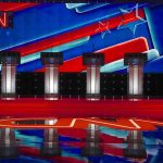 Shock Debate Clip Resurfaces After Kirk’s Death Debate stage with four podiums and colorful star backdrop