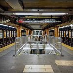 Subway platform with stairwell and tracks on both sides