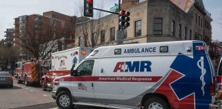 Ambulance and fire trucks at an urban intersection