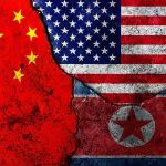 China Claims To Support Denuclearization—So Why The Silence In Pyongyang? Composite of China, United States, and North Korea flags on cracked wall