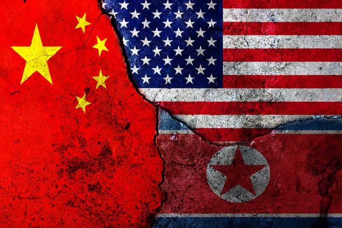 shutterstock_618373403 Composite of China, United States, and North Korea flags on cracked wall
