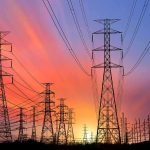 Power transmission towers and lines at sunset
