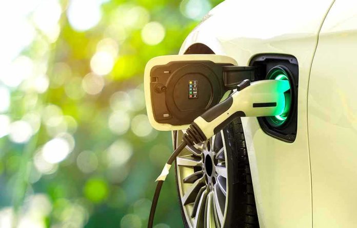shutterstock_750610873 Electric car charging port with plugged-in cable