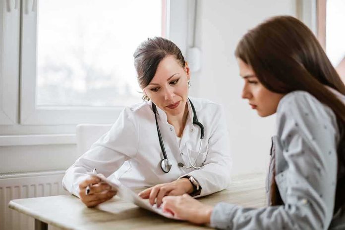 shutterstock_796803439-1 Doctor consulting a patient at a desk