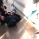 Realtor Arrested at LAX in Chinese Spy Case person being restrained on the ground in a hallway