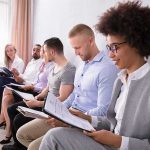 This School Policy Kept Parents Out Of The Loop Group of job applicants sitting in a row reviewing documents
