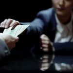 Gas Price Spike Warps Inflation Picture Hands exchanging cash across a table