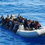 Dontrelle Inman and Colin David Jones among a crowded inflatable boat at sea