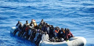 Dontrelle Inman and Colin David Jones among a crowded inflatable boat at sea