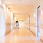 Anti-Plague Lab Worker Dies, 200 Monitored Hospital corridor with doors and medical cart