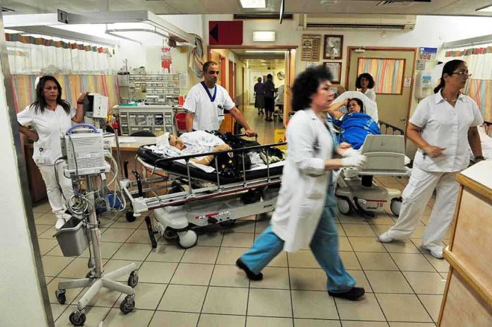 Hospital emergency room with staff moving patients on stretchers