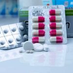 Assorted pills and blister packs on a pharmacy counter