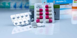 Assorted pills and blister packs on a pharmacy counter