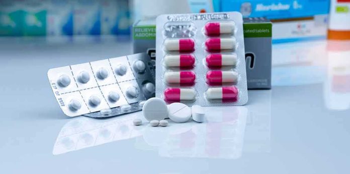 shutterstock_1751464088 Assorted pills and blister packs on a pharmacy counter