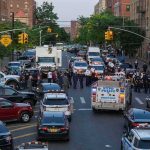 U.S. Marshals Capture Fugitive After Cop Injured Police vehicles and officers block a city street during an active scene