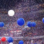 State Department Official’s Shocking NBA Incident Blue and white balloons with confetti falling over a crowded indoor arena