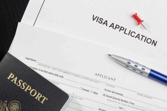 Visa application form with passport and pen